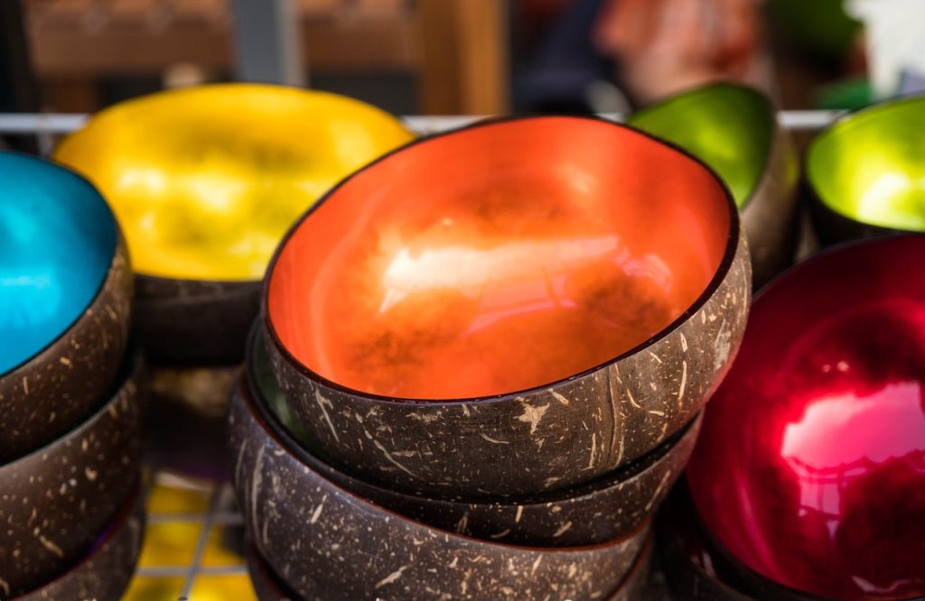 Coconut shell halves with decorative colored glazes on the inside