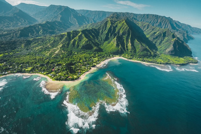 An aerial photo of the shores and forests of Kauai