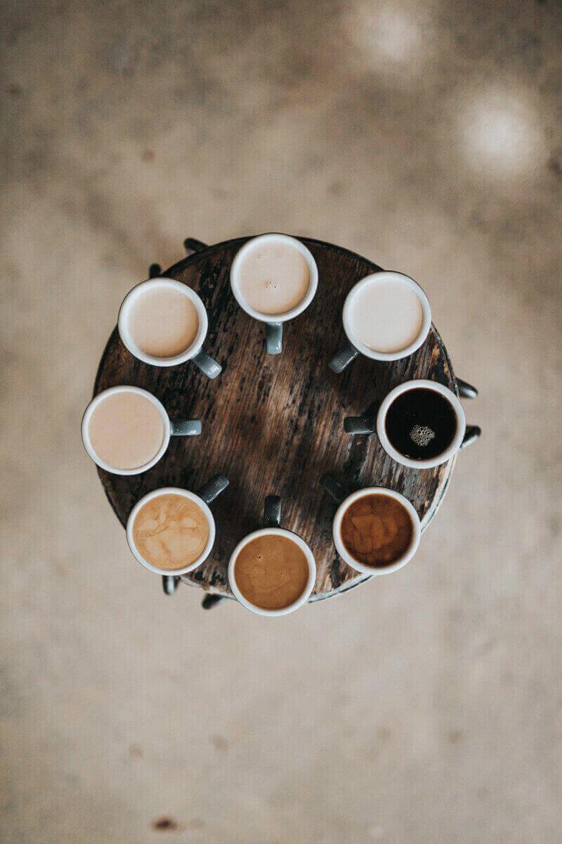 Multiple coffee mugs circled around a coffee table.
