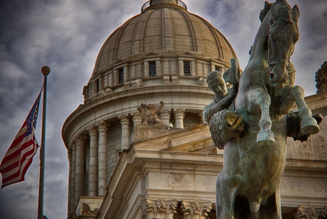 klahoma State Capitol building with cowboy and bronco statue in foreground