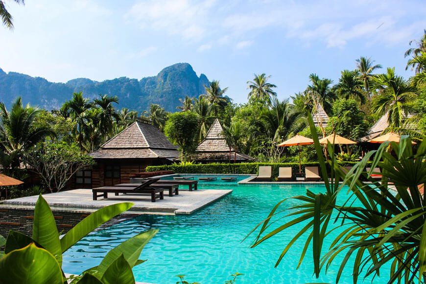 A swimming pool and palm trees in Ao Nang, Thailand