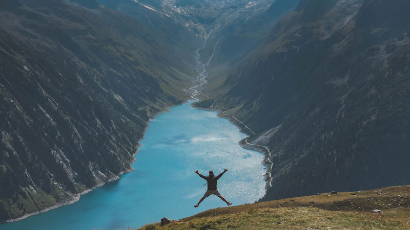 Person Jumping on mountain