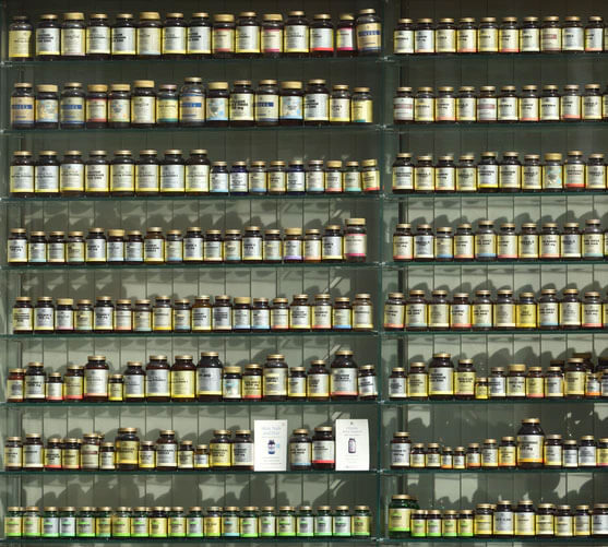 Variety of bottles sit on stacks of shelves