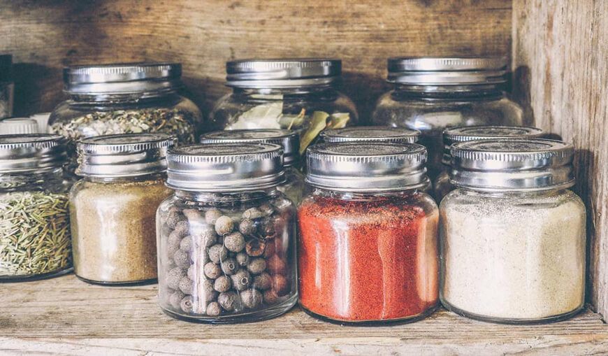 An Arrangement of Glass Jars Full of Spices and Herbs