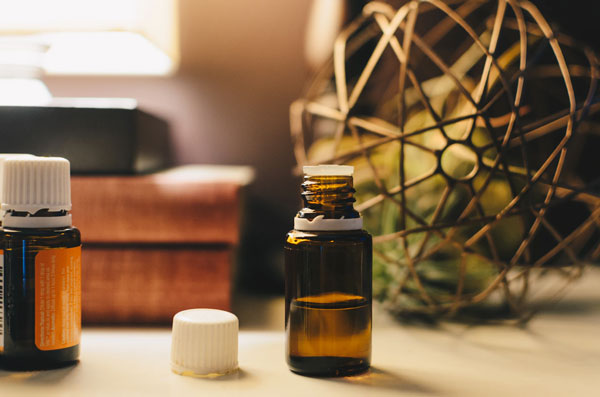 Two bottles of liquid kratom tinctures on a decorated desk.