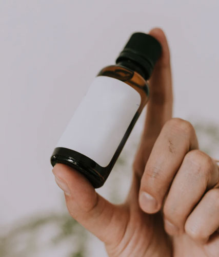 A man holds a kratom tincture bottle.