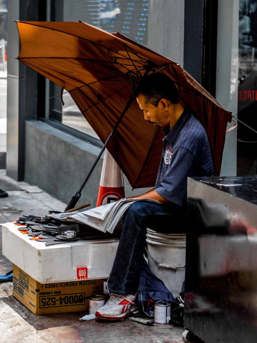 A street vendor reads the newspaper in Kuala Lumpur, Malaysia.