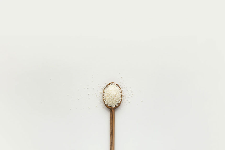 An image of a wooden spoon holding a small amount to demonstrate what microdosing is